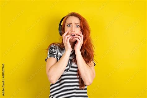 Shocked Young Beautiful Red Haired Woman Wearing Striped Shirt Over