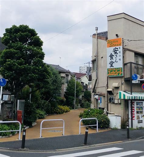 An Empty Street With Buildings And Trees On Both Sides In Front Of A