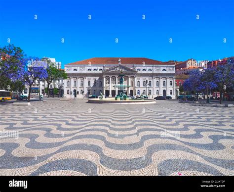 Beautiful Rossio Square In Lisbon In Summer With Purple Trees Stock