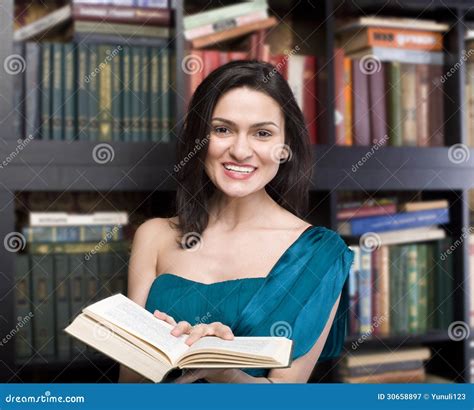 Portrait Of Beauty Young Woman Reading Book In Library Stock Image