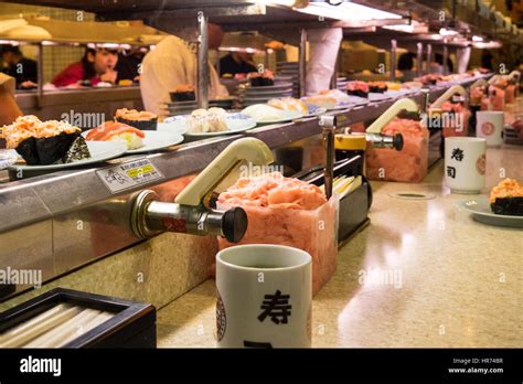 A Sushi Restaurant Where The Food Is Presented On A Sushi Train In