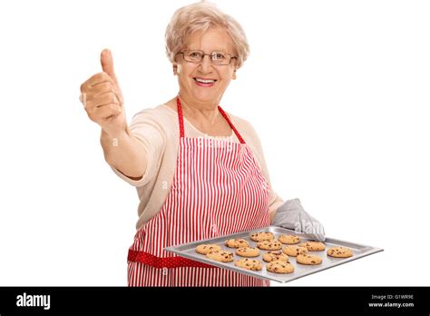 Mature Lady Holding A Tray With Chocolate Chip Cookies And Giving A