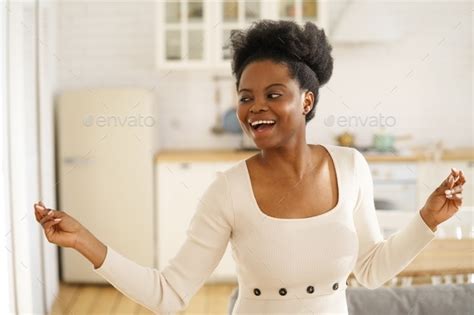 Happy Black Girl Wear Fashion Dress Dancing Enjoying Listening To Music Having Fun Alone At