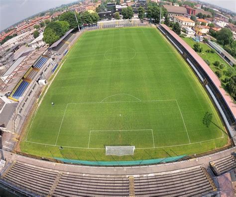 An Aerial View Of A Soccer Field In The Middle Of A City With Lots Of Grass