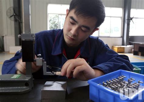 photo  chinese engineer records measurements  small aviation parts