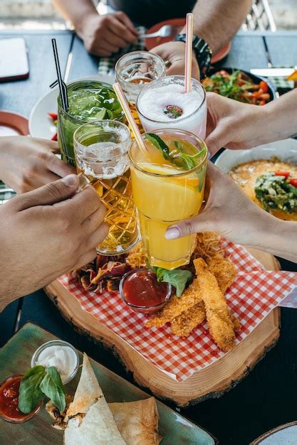 Premium Photo Group Of People Eating And Drinking In Cafe