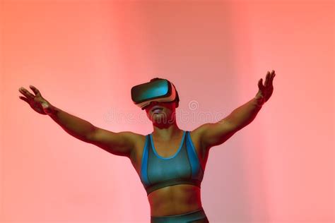 African American Woman Streamer Playing Video Game Using Virtual Reality Glasses At Gaming Room