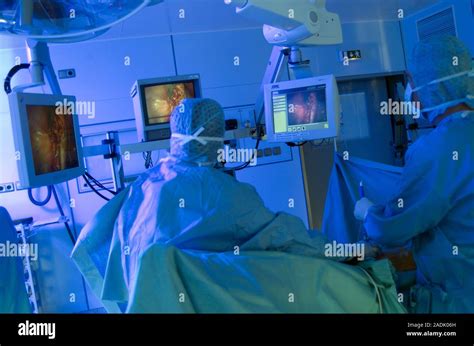Ovarian Cyst Removal Surgeons Looking At The Displays On Screens