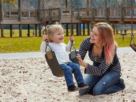 Mother And Daughter In A Swing At The Park Stock Photo Image Of