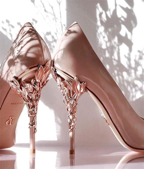 A Pair Of Pink High Heeled Shoes Sitting On Top Of A Table