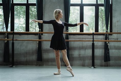 Female dancer performing ballet dance in classroom · Free Stock Photo