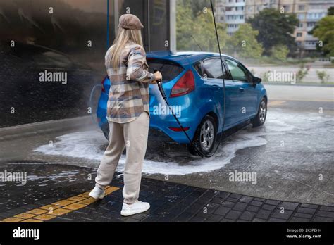 Woman Washing A Car In A Self Service Car Wash Station With Wahing Foam Wash Car Self Service