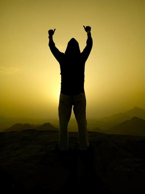 Premium Photo Rear View Of Silhouette Man With Arms Raised Standing