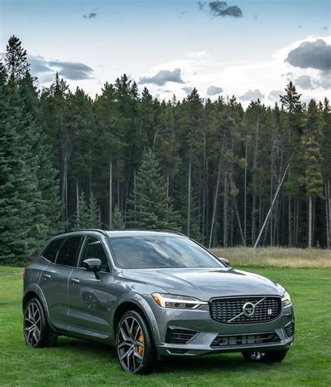 A Silver Volvo Suv Parked In The Grass