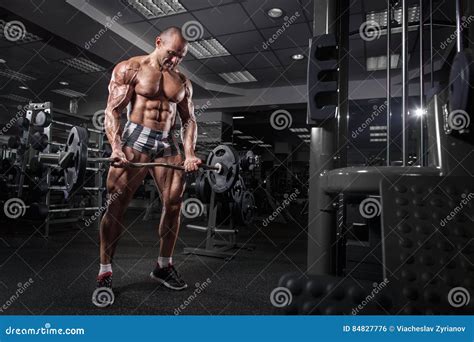 Bodybuilder In Gym Training With Bar Workout Exercises Sportsman With Naked Shirtless Torso