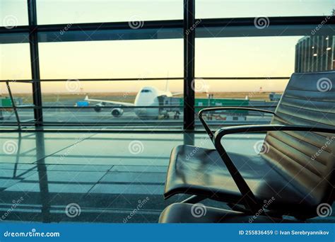 Chairs in the Airport Lobby and Aircraft Silhouette in the Dusk Stock ...