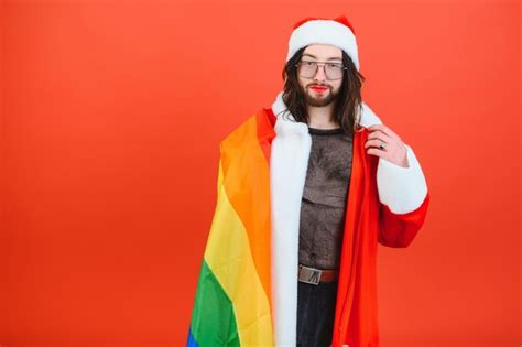 Premium Photo Gay Man Dressed As Santa Claus Holding A Multicolored Flag