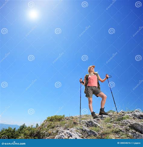 Young Female With Hiking Poles Posing At Sunny Day In Mountain Stock