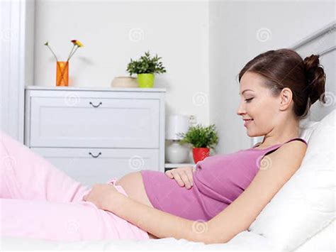 Pregnant Woman Lying On Bed And Touching Her Belly Stock Image Image