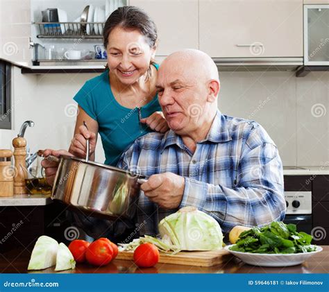 Happy Mature Couple Cooking Together Stock Image Image Of Expressive