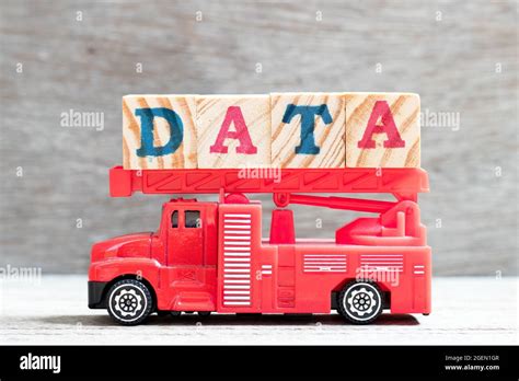 Toy Fire Ladder Truck Hold Letter Block In Word Data On Wood Background