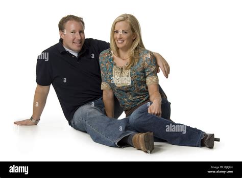 Happy sitting couple Stock Photo - Alamy