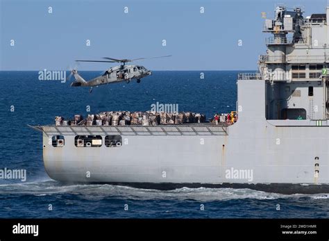 An MH 60S Sea Hawk Helicopter Hovers Over The Flight Deck Of USNS