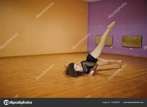 Curly Brunette Plus Size Model Doing Acrobatic At Dance Room Stock