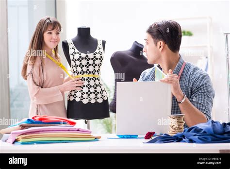 Male Tailor With Female Student In Workshop Stock Photo Alamy