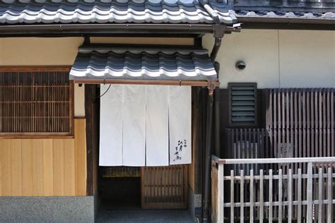 An Outside View Of A Building With White Towels Hanging From The Roof