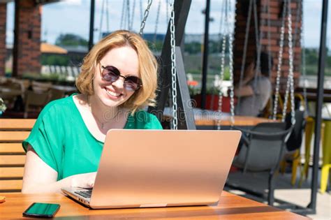 Happy Smiling Girl In Sunglasses Using Application On Digital Laptop In