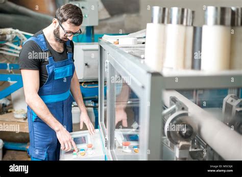 Man Operating Machine Which Makes Paper Tubes Stock Photo Alamy