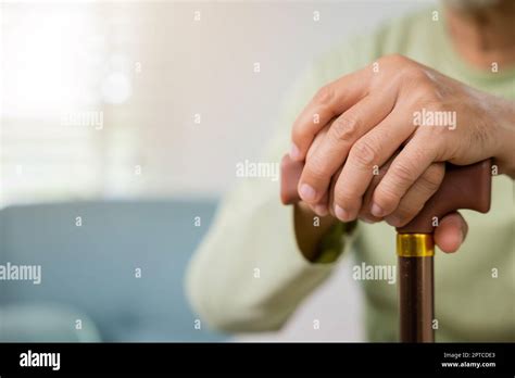 Closeup Hands Of Senior Disabled Man Holding Walking Stick Old Man