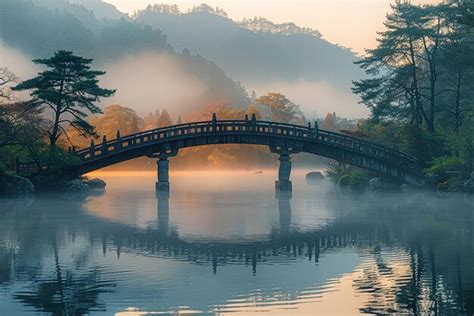 Premium Photo A Bridge Spanning A Tranquil River At Sunrise