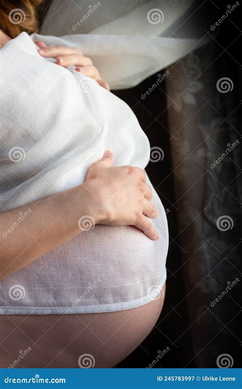 Close Up And Detailed Profile Shot Of A Pregnant Woman Her Bulging Belly Covered With A