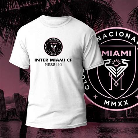 A White T Shirt With The Miami Club Logo On It Next To A Black And