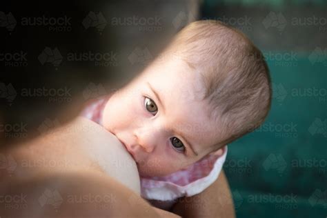 Image Of Baby Breast Feeding While Looking Up At Her Mother Austockphoto