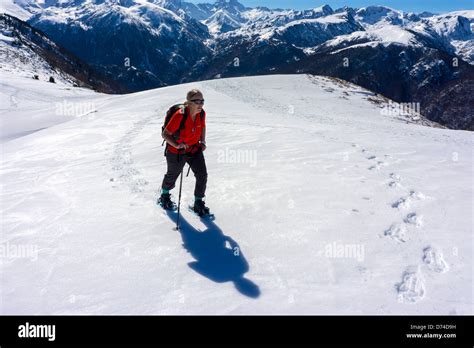 Female Figure In Red Snowshoeing Plateau De Beille Ariege French