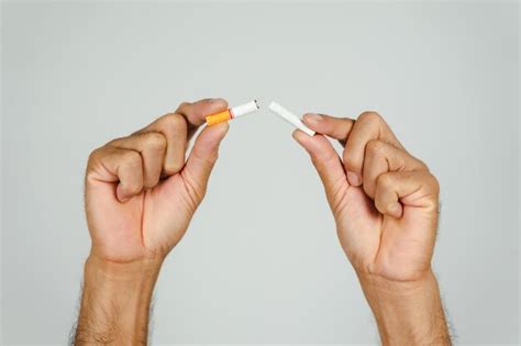 Premium Photo Close Up Of Hand Holding Cigarettes