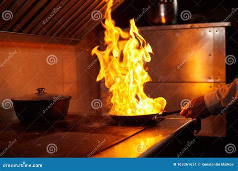 Flambe Fire In Frying Pan Professional Chef In A Commercial Kitchen Cooking Stock Image