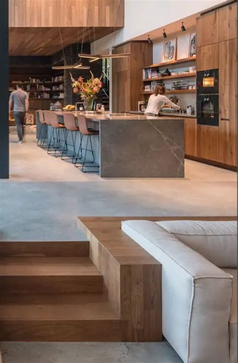 A Living Room Filled With Furniture Next To A Kitchen