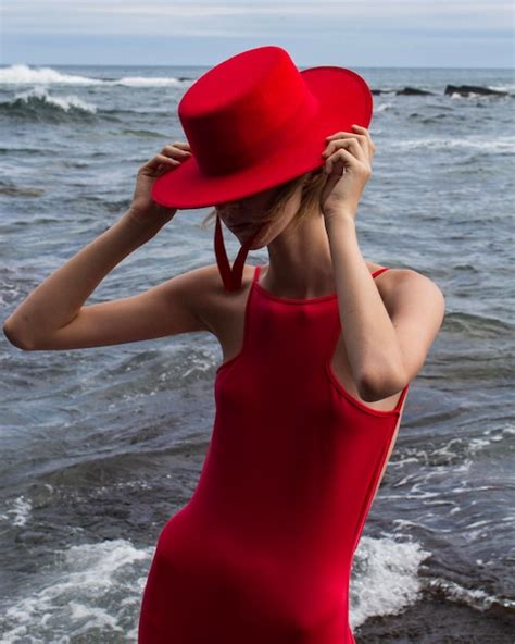 Premium Photo | A model wears a red hat and a red hat.