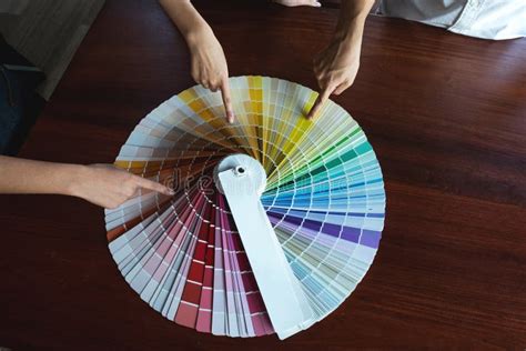 Graphic Designers Choose Colors From The Color Bands Samples For Design