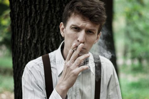 Young man smoking cigarette — guy, fashion - Stock Photo | #133480450