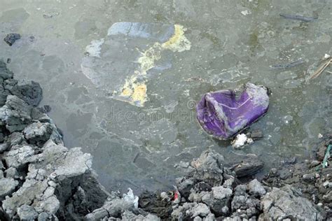 A Magenta Plastic On The Water Garbage In The Canal Pollution And