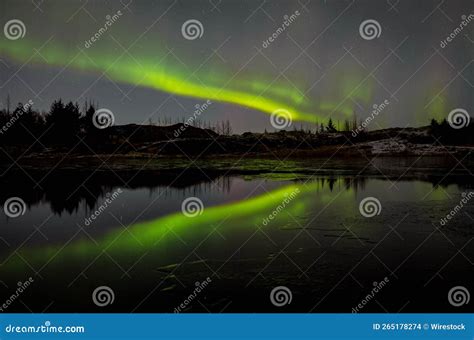 Scenic Shot Of An Aurora Borealis Reflecting On A Lake In Iceland