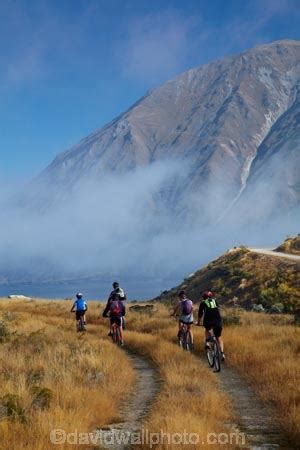 Cyclists On Alps 2 Ocean Cycle Trail And Mist Over Lake Ohau And Ben