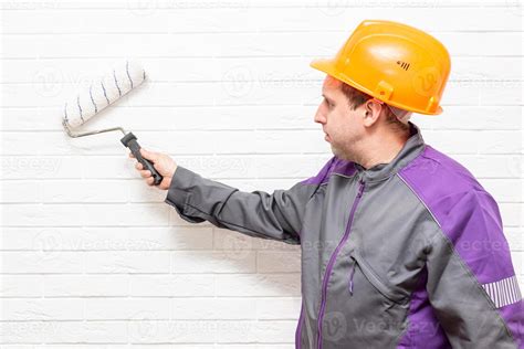 Worker Paints The White Wall White Cushion 13427536 Stock Photo At Vecteezy