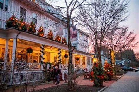 People Are Walking In Front Of A Building Decorated For Christmas