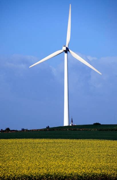 Premium Photo Wind Turbines On Field Against Sky